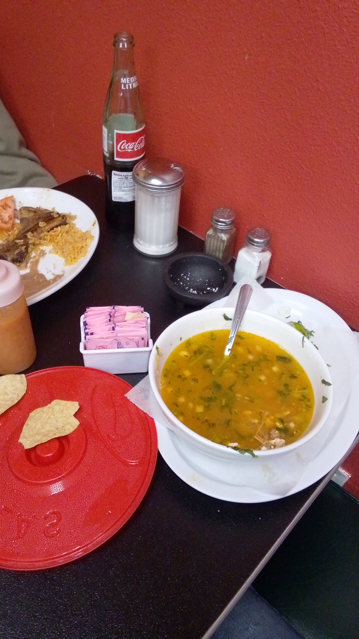 Bowl of menudo soup served with tortilla chips