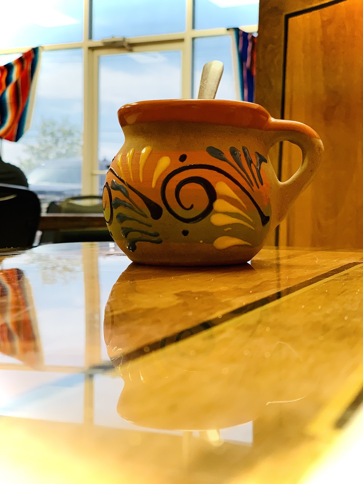 Hand-painted clay salsa pot on the table